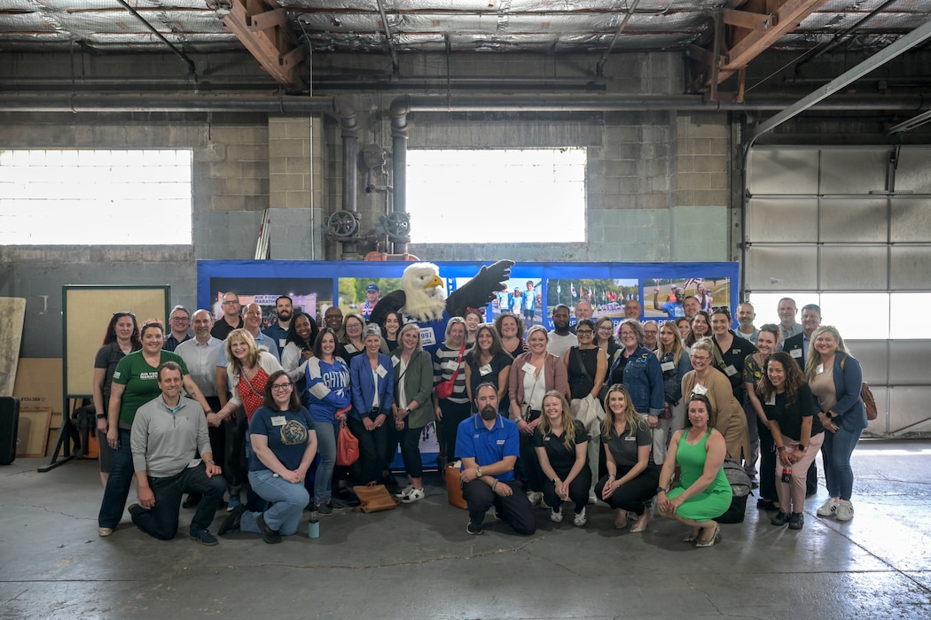 A group of individuals stand in front of the "Centrifuge" for a photo.