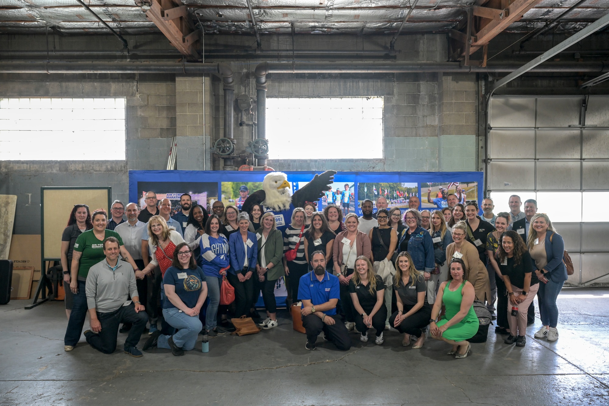 A group of individuals stand in front of the "Centrifuge" for a photo.
