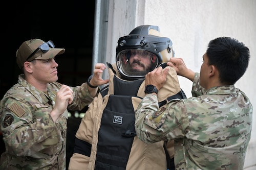 A group of individuals stand in front of the "Centrifuge" for a photo.