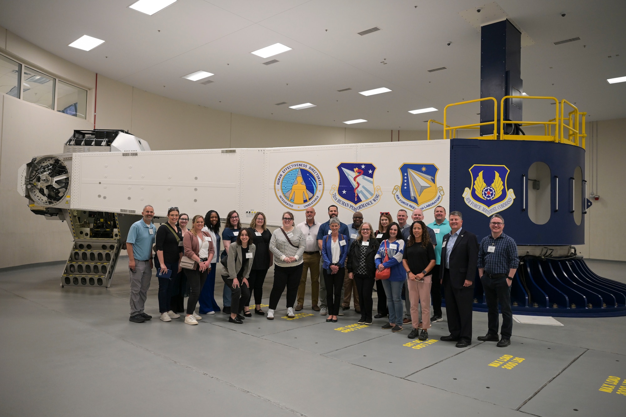 A group of individuals stand in front of the "Centrifuge" for a photo.