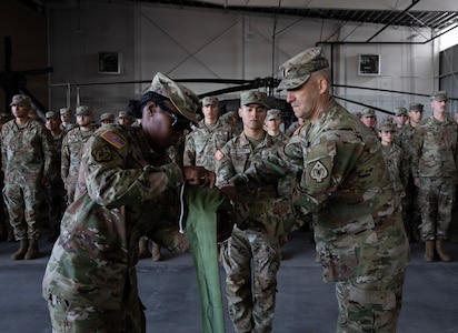 U.S. Army Capt. Jamee Finley, left, and 1st Sgt. Paul Jones, right, the company command team for the 150th Maintenance Company, case the colors at the Washoe County Armory in Stead, Nevada, April 18, 2026.