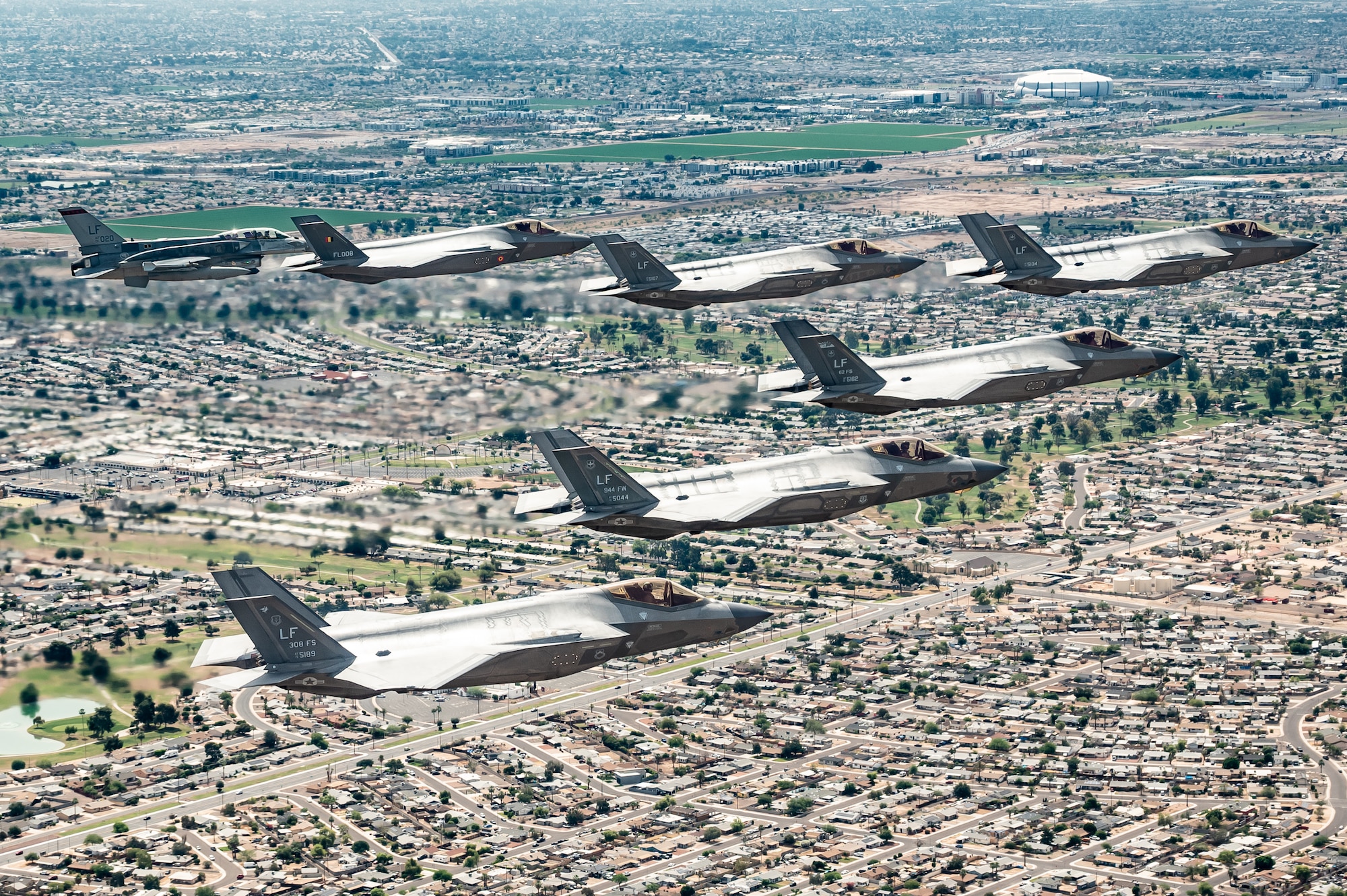 A Republic of Singapore Air Force F-16D Fighting Falcon, a Belgian Air Component F-35A Lightning II, and U.S. Air Force F-35A Lightning II aircraft assigned to the 56th Fighter Wing fly in formation