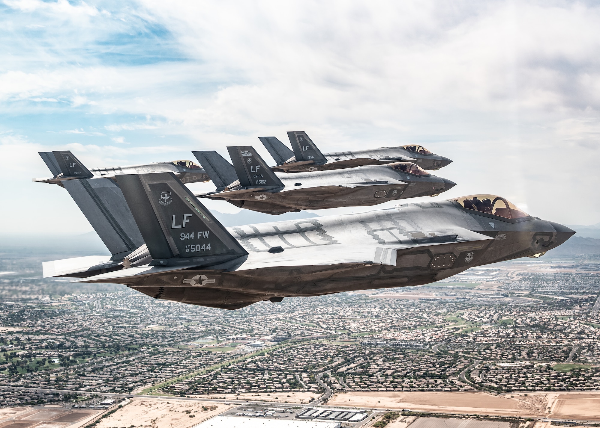 U.S. Air Force F-35A Lightning II aircraft assigned to the 56th Fighter Wing fly in a tight formation over the Sonoran Desert