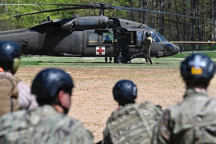 First-year medical students at the Uniformed Services University of the Health Sciences conduct a medical evacuation training exercise with a UH-60L MEDEVAC Black Hawk assigned to the D.C. Army National Guard Aviation Battalion in Bethesda, Maryland, on April 10, 2026. The training provided medical school applicants and first-year medical students with instruction in medical evacuation procedures and tactical combat casualty care (TCCC).