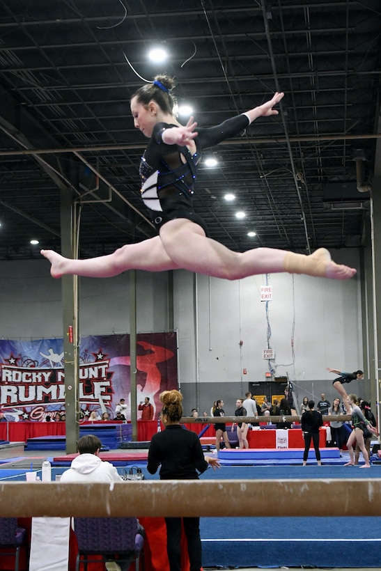 Department of War Education Activity (DoWEA) Lejeune High School junior Haley Cochran performs on the balance beam during a gymnastics competition. Cochran, a Level 9 gymnast, recently qualified for the USA Gymnastics Eastern National Championships while balancing rigorous training, academics and the demands of a military family lifestyle. DoWEA operates as a field activity of the Office of the Secretary of War. It is responsible for planning, directing, coordinating, and managing prekindergarten through 12th-grade educational programs for the Department of War. DoWEA operates 161 accredited schools in 9 districts in 11 foreign countries, seven states, Guam, and Puerto Rico, serving over 66,000 military-connected students. DoWEA Americas operates 50 accredited schools across two districts on 16 military installations, including Army, Navy, Marine Corps, Air Force, and Coast Guard bases in seven states, Puerto Rico and Cuba. Committed to excellence in education, DoWEA fosters well-rounded, lifelong learners through DoWEA’s academic programs, ensuring continued innovation and excellence, while advancing a strong focus on patriotism, classical learning, and civics education in support of military-connected students worldwide.