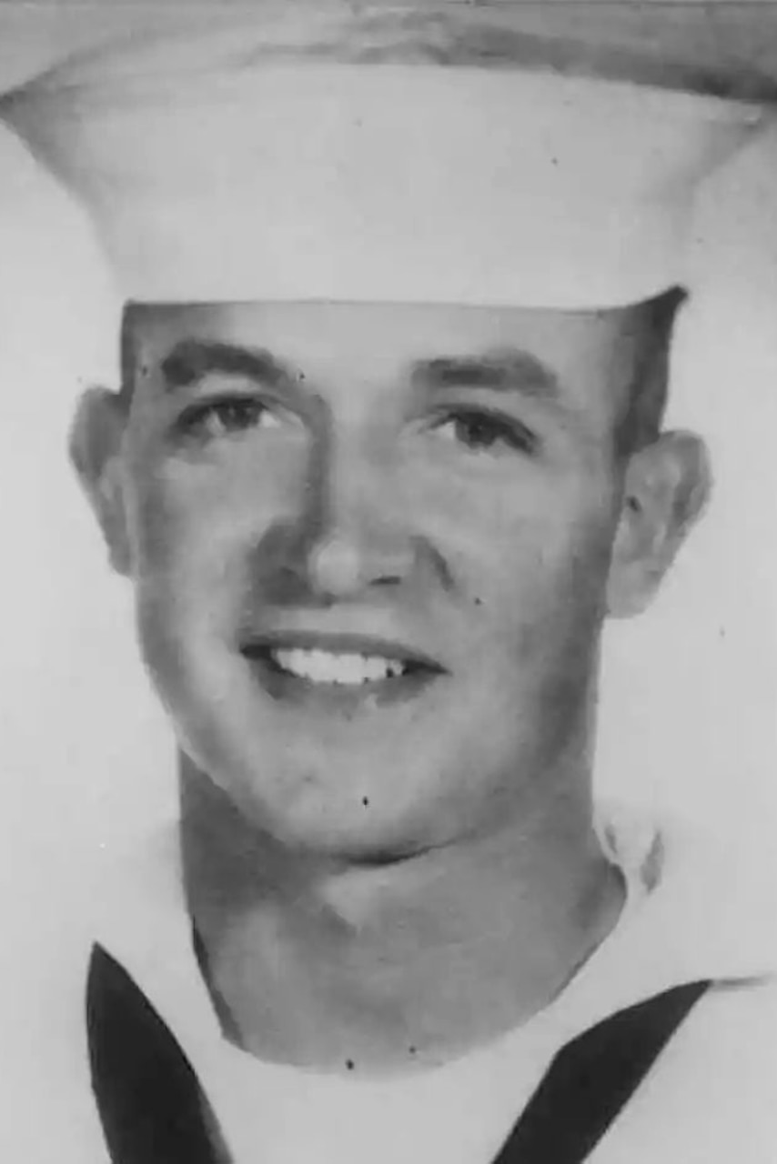 A man in a military dress uniform poses for a photo.