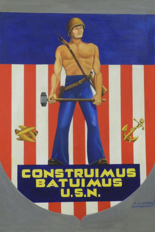 A poster shows a shirtless man with a helmet on, carrying a sledgehammer. Below the man reads, "Construimus Batuimus, U.S.N."
