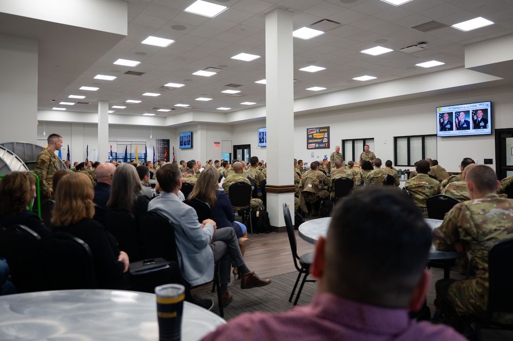 U.S. Air Force Col. Matthew Norton, 17th Training Wing commander, and Chief Master Sgt. Derek Neill, 17th Training Wing command chief, welcomes incoming tech students at the Cressman Dining Facility.