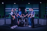 U.S. Service members pose beside a championship trophy before the 2026 Armed Forces Esports Championship at Localhost in Philadelphia Pennsylvania, April 23, 2026. Service members competed in organized esports competition playing Marvel Rivals for championship honors while representing their respective services. Armed Forces Sports brings together service members from the Army, Marine Corps, Navy, Coast Guard, Air Force, and Space Force to compete at the national level. Armed Forces Sports promotes physical fitness, cognitive readiness, teamwork, and competitive opportunities for military members while supporting recruitment and retention efforts and strengthening partnerships through emerging sports platforms. (DoW photo by U.S. Navy Mass Communication Specialist 2nd Class Christopher Suarez)