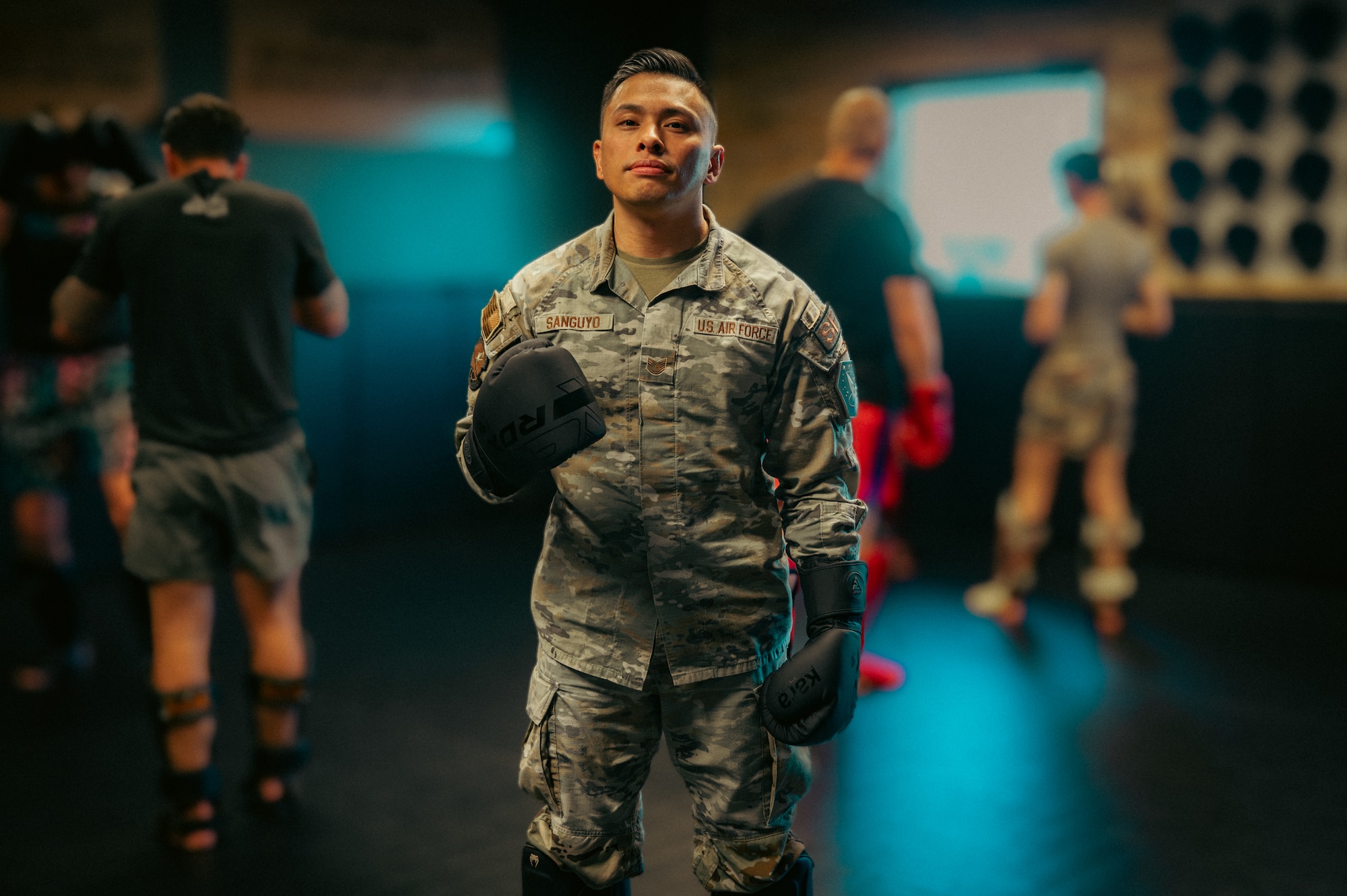 Man poses for photo in a padded gym