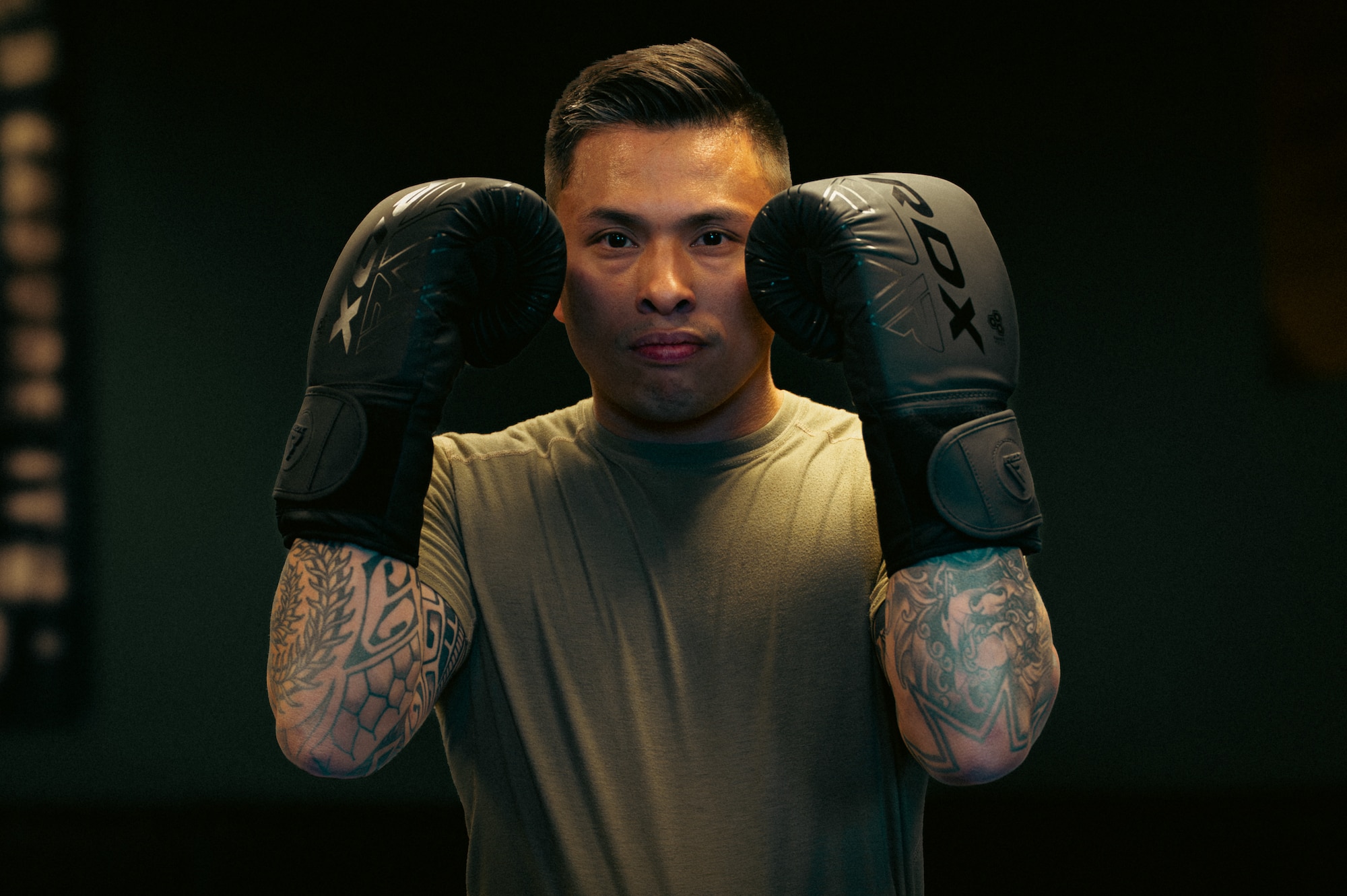 Man poses for photo in a padded gym
