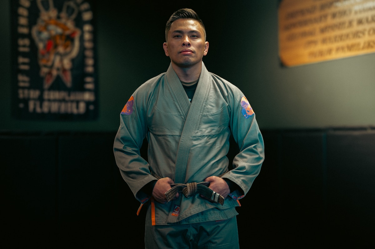 Man poses for photo in a padded gym