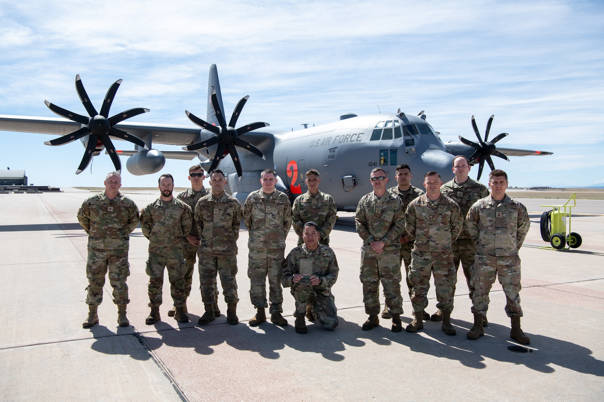 Airmen pose for a photo with their award.
