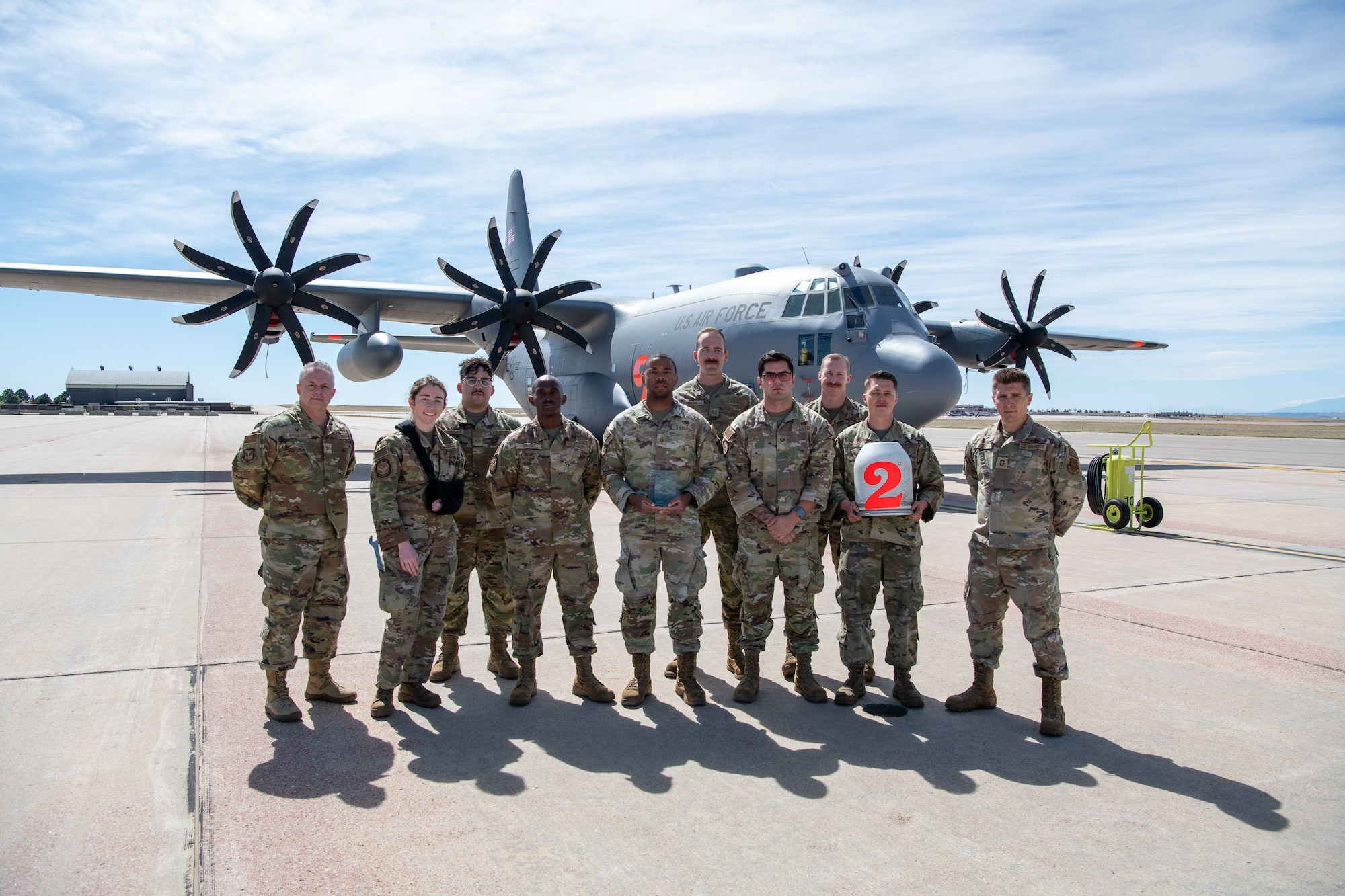 Airmen pose for a photo with their award.