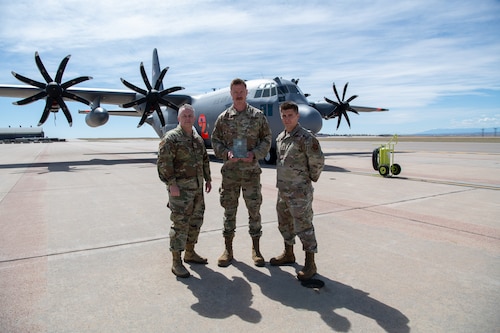 Airmen pose for a photo with their award.