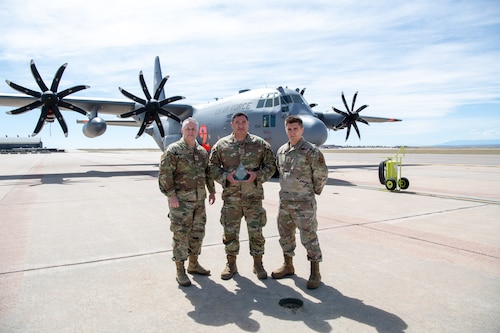 Airmen pose for a photo with their award.