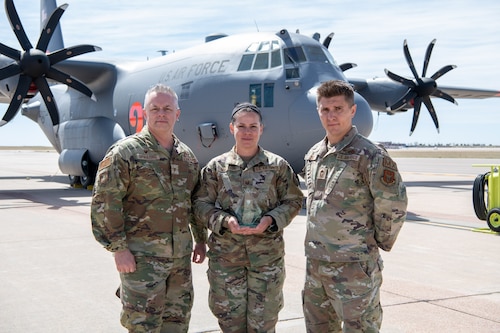 Airmen pose for a photo with their award.