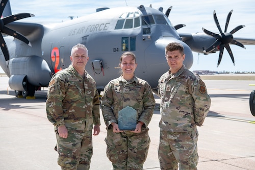 Airmen pose for a photo with their award.