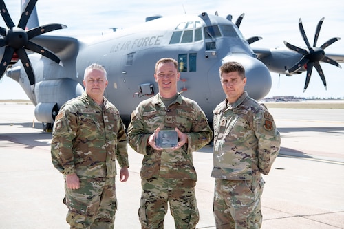 Airmen pose for a photo with their award.
