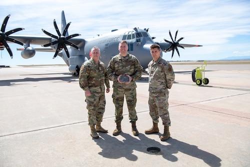 Airmen pose for a photo with their award.