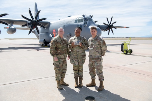 Airmen pose for a photo with their award.