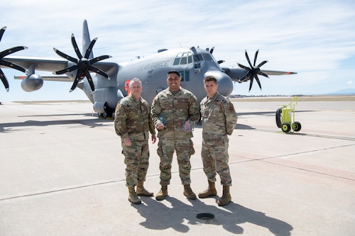 Airmen pose for a photo with their award.