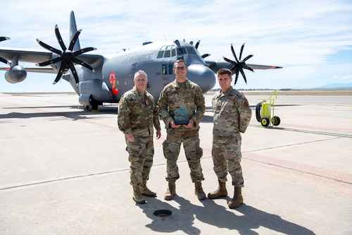 Airmen pose for a photo with their award.
