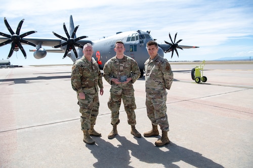 Airmen pose for a photo with their award.