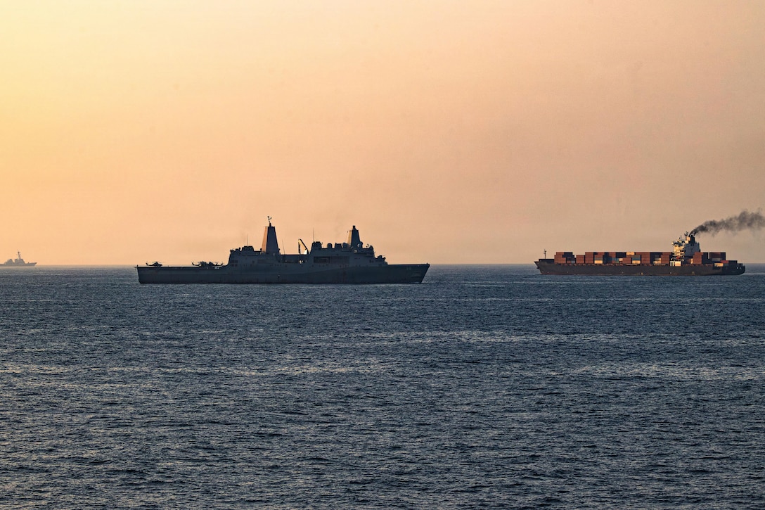 Two ships float near each other on the sea, with the horizon in the background.