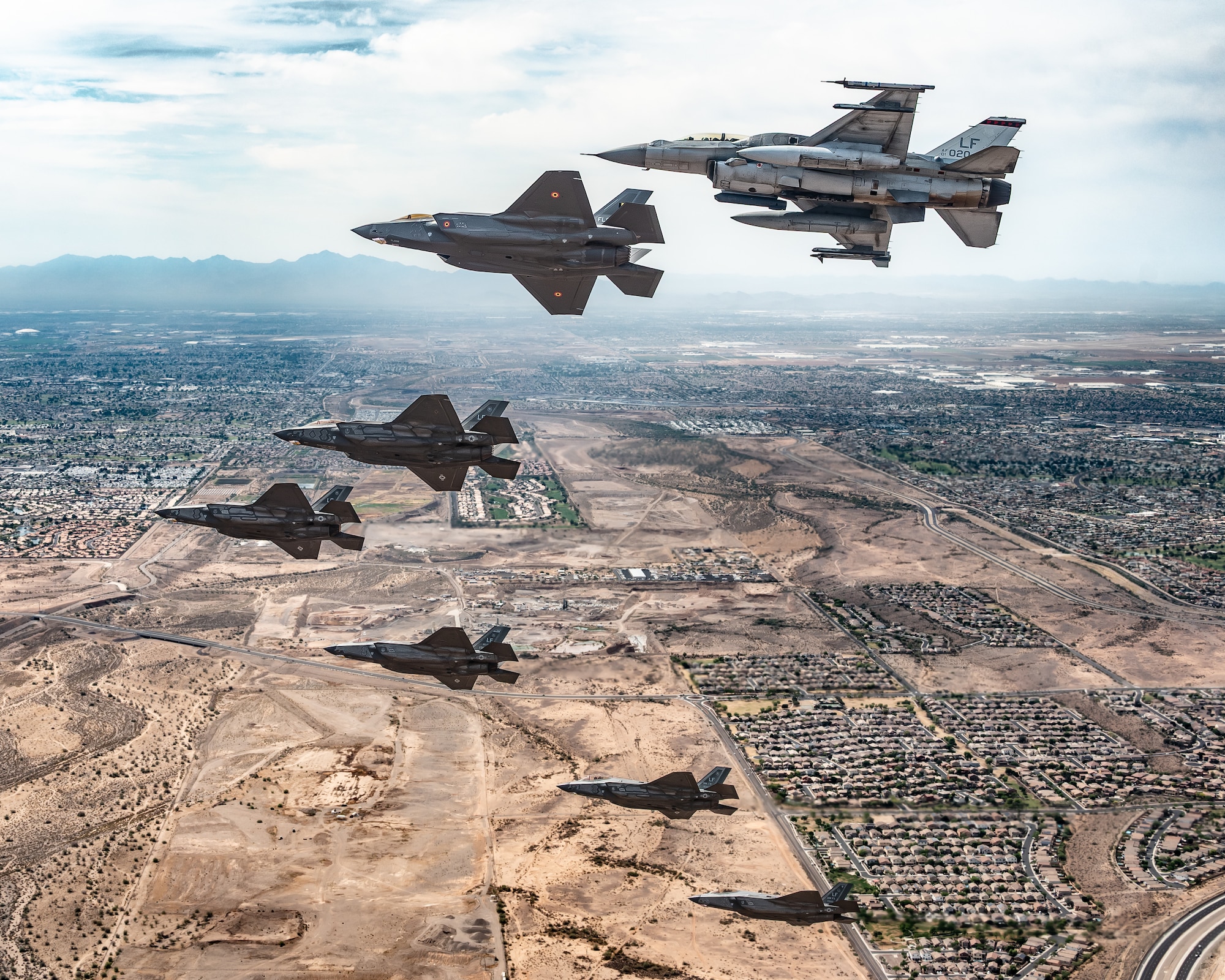 A Republic of Singapore Air Force F-16D Fighting Falcon, a Belgian Air Component F-35A Lightning II, and U.S. Air Force F-35A Lightning II aircraft assigned to the 56th Fighter Wing fly in formation