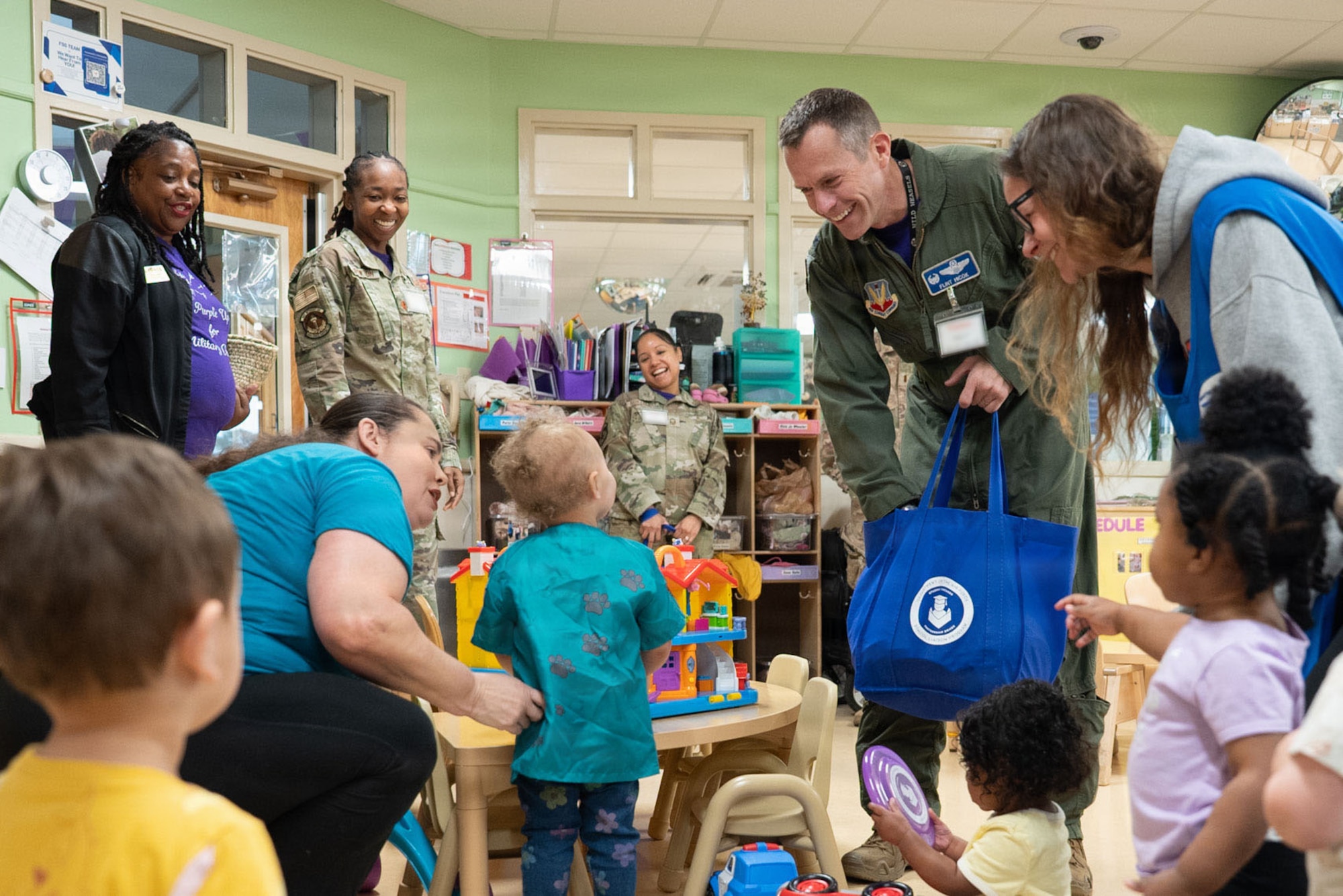 An Air Force pilot hands out trinkets to kids.