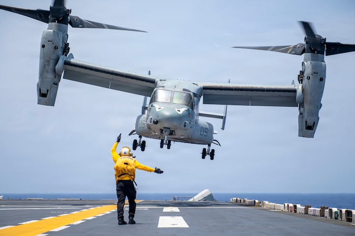 Aviation Boatswain’s Mate (Handling) 3rd Class Delos Reyes, assigned to Wasp-class amphibious assault ship USS Boxer (LHD 4), directs an MV-22B Osprey assigned to Marine Medium Tiltrotor Squadron (VMM) 163 (Reinforced), 11th Marine Expeditionary Unit, as it takes off from the ship’s flight deck during flight operations, April 18, 2026