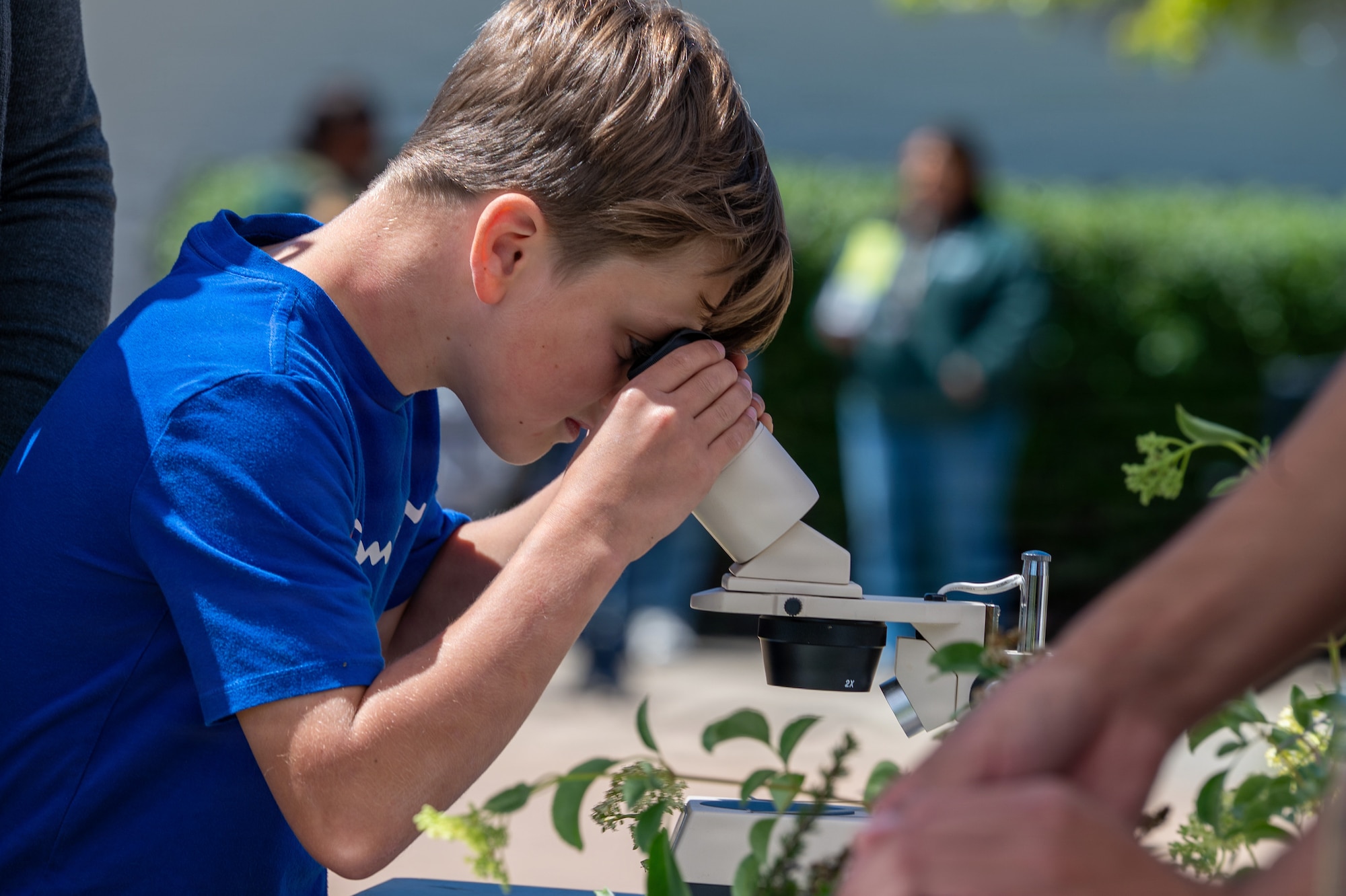 A child looks through a microscope.