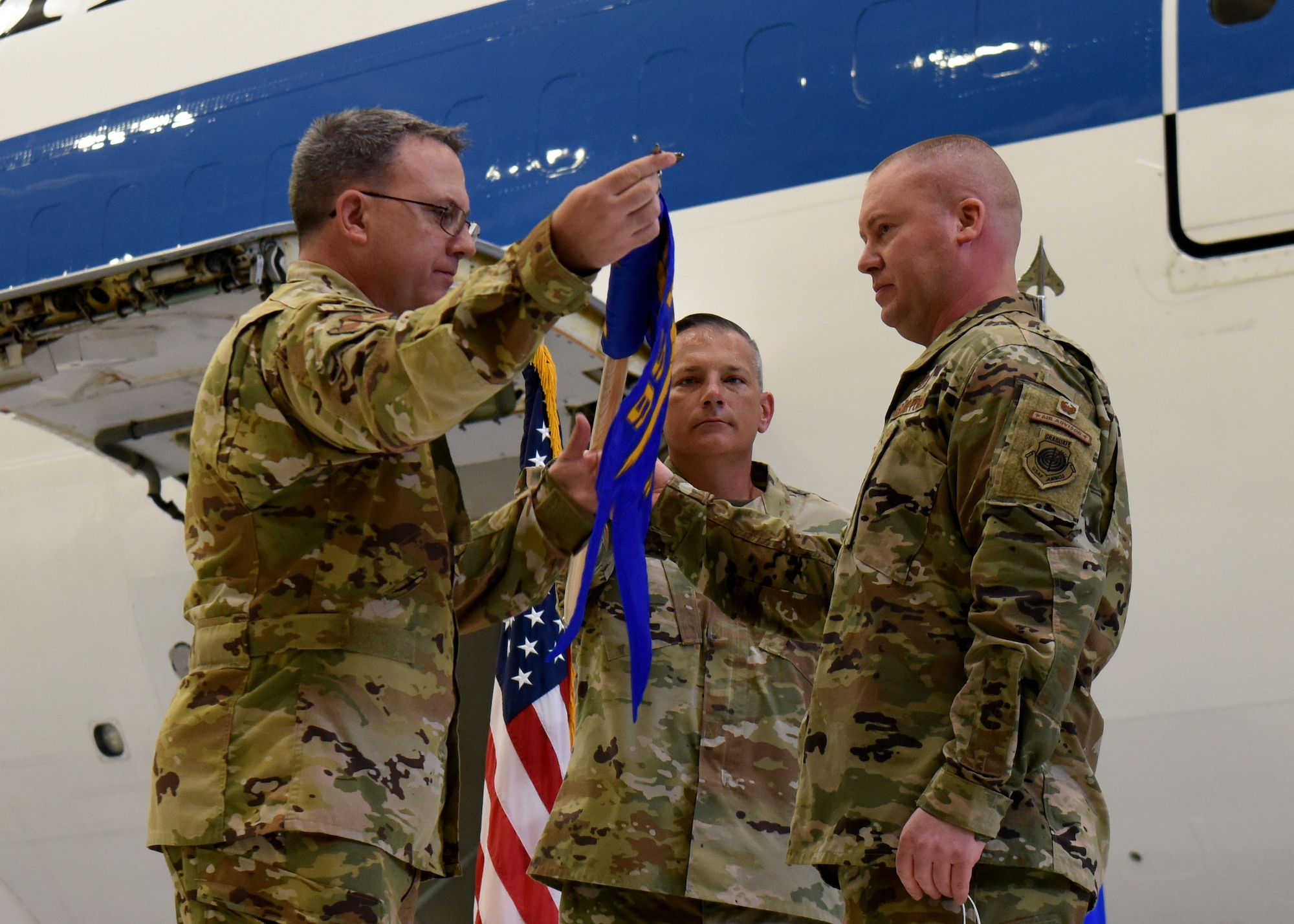 Col. David Leaumont unfurls the 95th Maintenance Group guidon