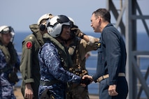 U.S. 7th Fleet Deputy Commander Rear Adm. Kyle Gantt, right, greets Japan Maritime Self-Defense Force (JMSDF) Surface Warfare Squadron 6 Commodore Capt. Jo Takemasa on the U.S. 7th Fleet flagship USS Blue Ridge (LCC 19) flight deck during a bilateral exercise with the JMSDF in the South China Sea, April 16, 2026. U.S. 7th Fleet, the Navy’s largest forward-deployed numbered fleet, routinely interacts and operates with allies and partners in preserving a free and open Indo-Pacific. (U.S. Navy photo by Mass Communication Specialist 1st Class Charles Oki)