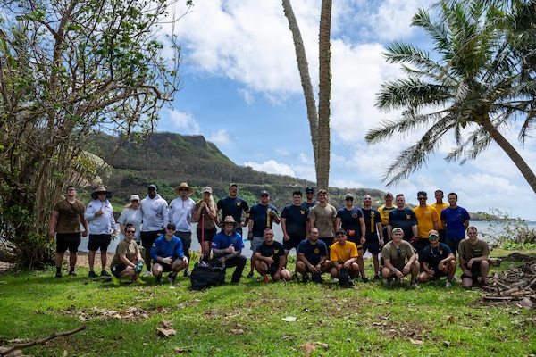 Sailors and civilians from Commander, Submarine Squadron 15 (CSS-15), pose for a group photo after participating in a beach cleanup following Super Typhoon Sinlaku. CSS-15 and other military commands across Guam are providing vital support to villages and civil authorities, strengthening crisis response and recovery efforts in the wake of Super Typhoon Sinlaku.