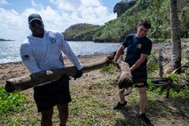 Sailors assigned to Commander, Submarine Squadron 15, participate in a beach cleanup following Super Typhoon Sinlaku. Super Typhoon Sinlaku, a Category 5 storm, moved through Guam and the Northern Marianas islands, bringing hurricane-force winds, heavy rain and high seas.