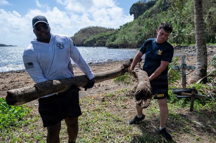 Sailors assigned to Commander, Submarine Squadron 15, participate in a beach cleanup following Super Typhoon Sinlaku. Super Typhoon Sinlaku, a Category 5 storm, moved through Guam and the Northern Marianas islands, bringing hurricane-force winds, heavy rain and high seas.