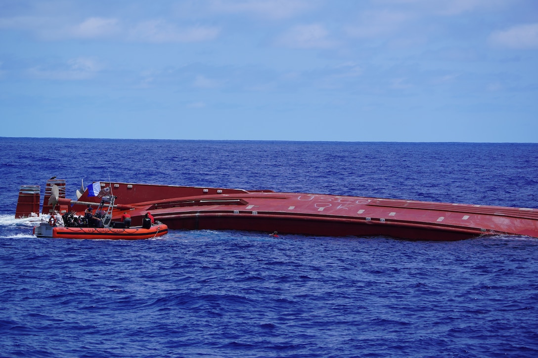 U.S. Coast Guardsmen assigned to the fast response cutter USCGC Frederick Hatch (WPC 1143) provide support as a parajumper assigned to the U.S. Air Force 31st Rescue Squadron enters the water near a capsized cargo vessel northeast of Pagan in the Commonwealth of the Northern Mariana Islands April 19, 2026. Parajumpers met up with the crew of fast response cutter USCGC Frederick Hatch (WPC 1143) and searched the interior of the Mariana, which initially experienced a disabled engine about 125 nautical miles northwest of Saipan on April 15. (U.S. Coast Guard photo, courtesy Cutter Frederick Hatch)