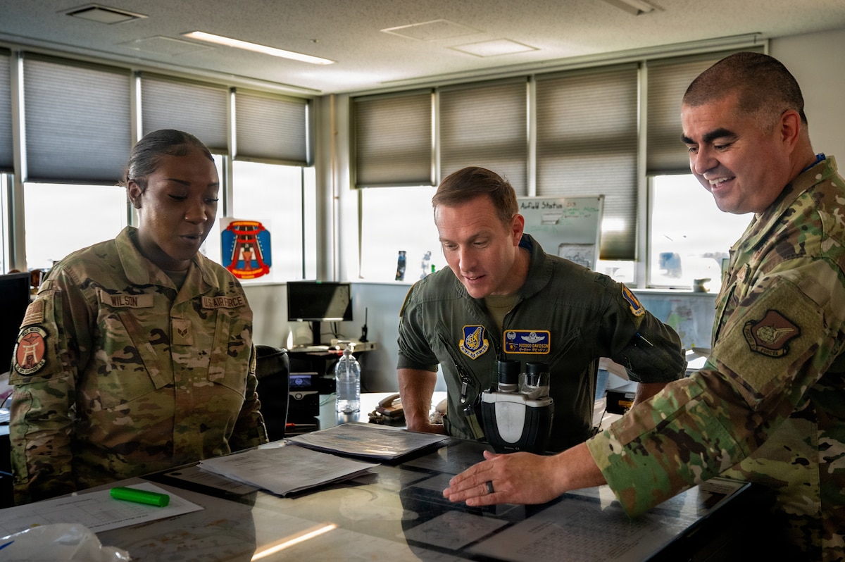 U.S. Air Force Senior Airman Jarese Wilson, 35th Operations Support Squadron airfield management shift lead, provides an overview of her responsibilities to Col. Paul Davison, commander of the 35th Fighter Wing (FW), and Chief Master Sgt. David Najera, 35th FW command chief,  at Misawa Air Base, Japan, April 20, 2026. Airfield management personnel are responsible for coordinating airfield operations, ensuring safe aircraft movement, and maintaining the overall efficiency of the installation’s flightline, which is critical to supporting timely and effective mission execution. (U.S. Air Force photo by Airman 1st Class Angelica Winther)
