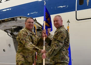 Col David Leaumont and Col. Brian Hassler pose for a photo with a guidon