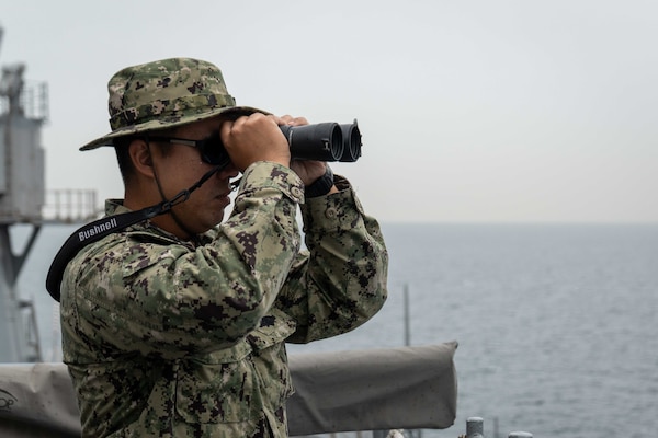 Master-at-Arms 1st Class Nico Villanueva watches for other vessels on the bridge wing aboard U.S. 7th Fleet flagship USS Blue Ridge (LCC 19) as the ship returns to Commander, Fleet Activities Yokosuka, Japan following a patrol in the Indo-Pacific region, April 23, 2026.