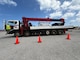 a man is getting into the cab of a large flatbed truck loaded with generators