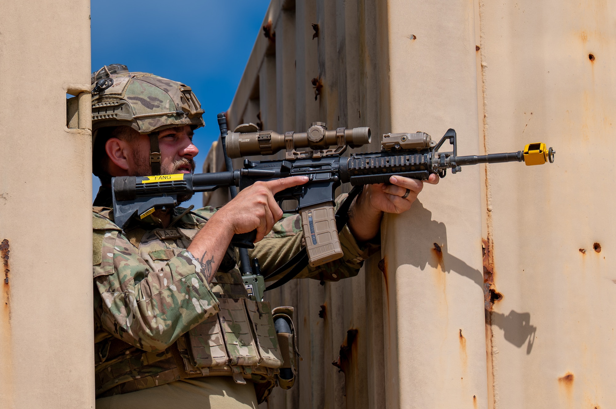 Man looks through scope.