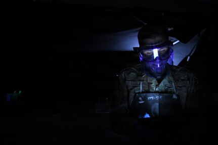 Staff Sgt. Marcos Aguilar, 146th Maintenance Squadron, reads a technical order while conducting magnetic particle inspections on C-130J Super Hercules components at March Air Reserve Base, Calif., April 12, 2026. The inspections identify cracks and ensure parts remain serviceable to prevent potential aircraft failures. (U.S. Air National Guard photo by Senior Master Sgt. Julianne Sitterding)