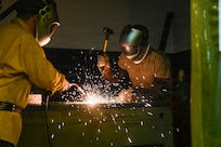 Staff Sgt. Scott Estes and Staff Sgt. Brandon Kennedy, aircraft metals technology technicians with the 113th Maintenance Squadron, weld sheet metal at Joint Base Andrews, Md., March 20, 2026. The metals shop repairs, designs and manufactures aircraft parts and equipment using welding and computer numerical control technology. (U.S. Air National Guard photo by Staff Sgt. Natalie Filzen)