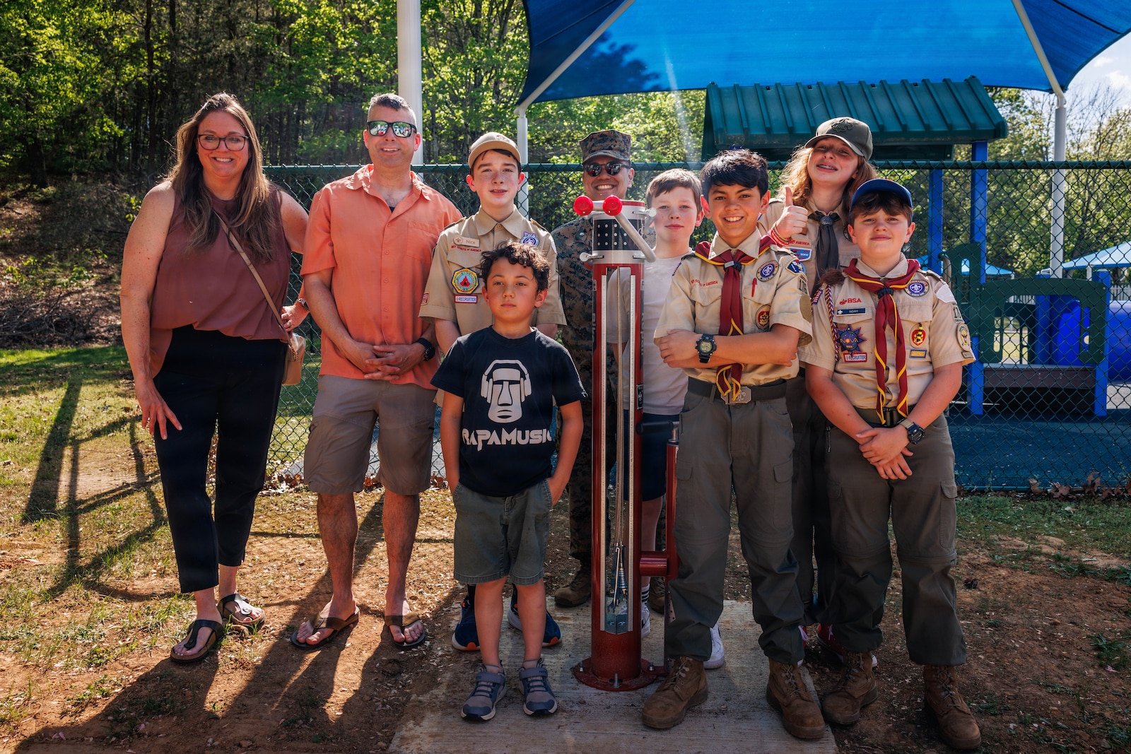 Life Scouts and Leaders pose for a photo with during Life Scout Santiago Carnice’s, troop 176, dedication 
ceremony at the Child Development Center on Marine Corps Base Quantico, April 17, 2026. Santiago is a 
13-year-old scout that was honored with a plaque on the newly installed permanent, all-weather bicycle 
repair station aboard MCB Quantico after he received the approval and completion of the project in order to receive his Eagle Scout Badge. Santiago contacted the Quantico Mountain Bike Club and presented his project to their board and received approval for $3,500 of funding. Santiago and his father worked through Natural Resources and Environmental Affairs and base facilities to acquire the permission to dig and secure a utilities company site review. The installation enhances trail safety, supports base recreation programs, and promotes self-sufficiency for trail users within the Quantico community. (U.S. Marine Corps Photo by Cpl. Harleigh Faulk)