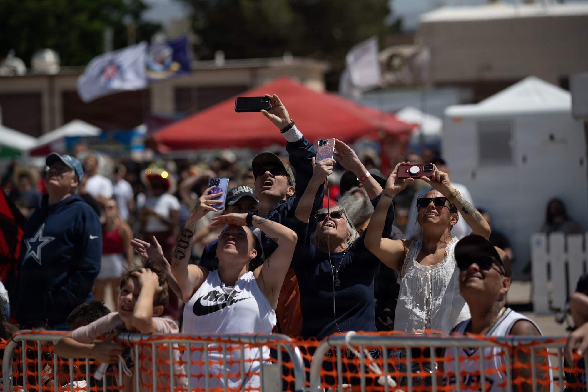 Attendees gaze into the sky to witness aerial performances.