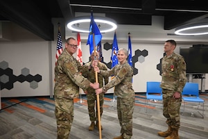 U.S. Air Force, Col. Jennifer L. King, incoming commander of the Eastern Air Defense Sector, receives the guidon from Lt. Gen. Luke Ahmann, commander of CONR-1st AF (AFNORTH/AFSPACE), during a change of command ceremony at the Griffiss Institute Innovare Advancement Center, April 17, 2026. (U.S. Air National Guard photo by Barbara Olney)