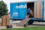 Boxes are loaded onto a moving truck as part of a Permanent Change of Station on Scott Air Force Base, Illinois, July 18, 2025. The Department of Defense established the Permanent Change of Station Joint Task Force to improve the moving experience for military members and their families. (U.S. Air Force photo by Staff Sgt. Stephanie Henry)